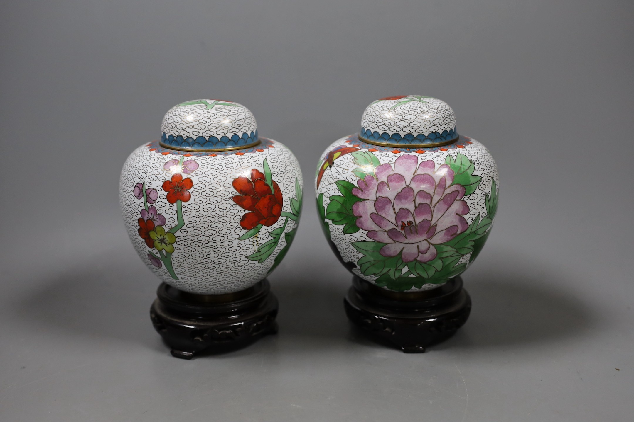 A pair of Chinese cloisonné enamel jars and covers on stands, total height 15.5 cm